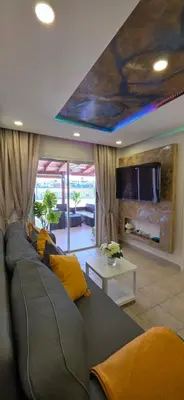 a living room with a gray couch with yellow pillows at CrisMari Napa in Ayia Napa