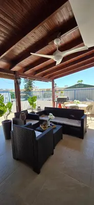 a patio with couches and a ceiling fan at CrisMari Napa in Ayia Napa