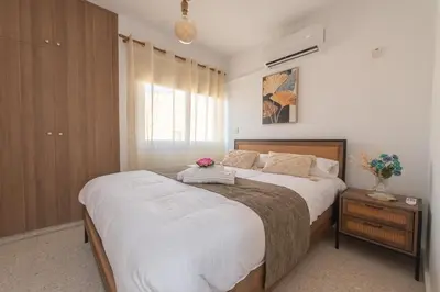 a bedroom with a large bed and a window at TelMar Larnaca 