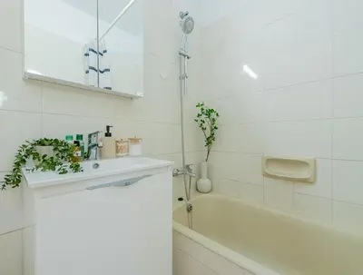 a white bathroom with a sink and a bath tub at TelMar Larnaca 