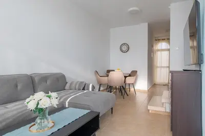 a living room with a couch and a table at TelMar Larnaca 