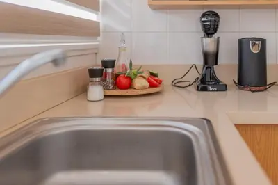 a kitchen counter with a sink and a blender at TelMar Larnaca 