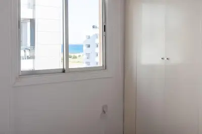 a white door with a window in a room at TelMar City - Harbour Sea View from the Veranda in Larnaka