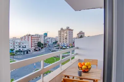 a balcony with a bowl of fruit on a table at TelMar City - Harbour Sea View from the Veranda in Larnaka