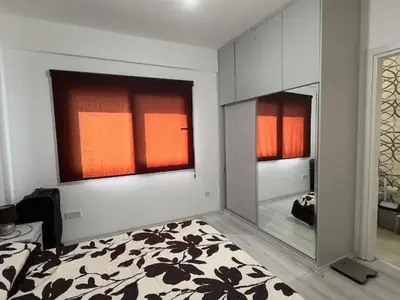 a bedroom with a bed and a large mirror at Modern apartment in North Nicosia