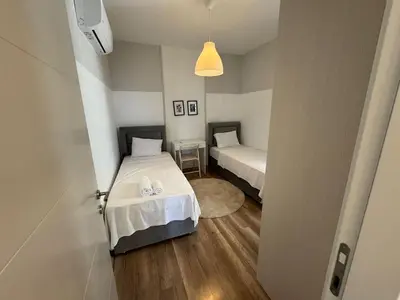 a small room with two beds and a hallway at Caesar Resort Spa Long Beach
