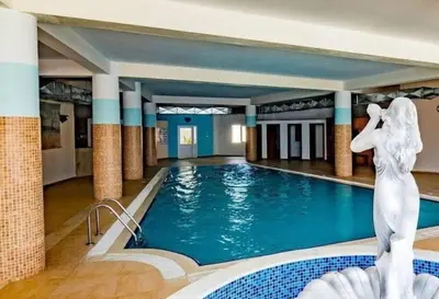 a pool with a mermaid statue in a hotel at Caesar Resort Spa Long Beach