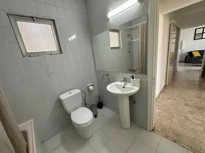 a bathroom with a toilet and a sink at Suite 52 - Two Bedroom Apartment with Shared Pool in Nicosia