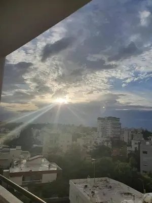 a view of a city with the sun in the sky at Suite 52 - Two Bedroom Apartment with Shared Pool in Nicosia