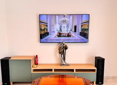 a living room with a tv on a wall at Family House in Limassol