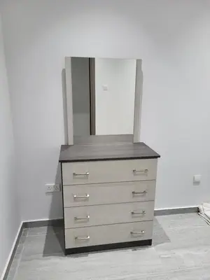 a dresser with a mirror on top of it at Chryso Apts Protaras in Paralimni