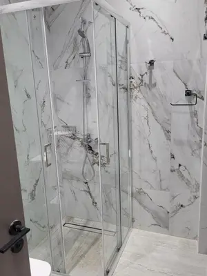 a shower with a glass door in a bathroom at Chryso Apts Protaras in Paralimni