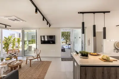 a kitchen with a counter and a living room at Protaras Leomi Seaview Villa in Protaras
