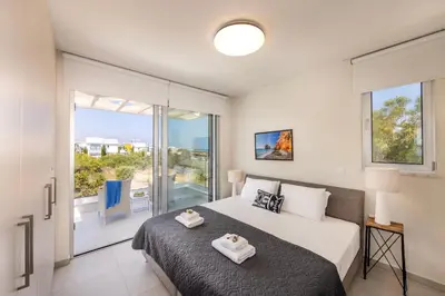 a bedroom with a bed with two towels on it at Protaras Leomi Seaview Villa in Protaras