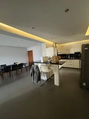 a kitchen and dining room with a table and chairs at 3 bedroom seafront apartment in Limassol
