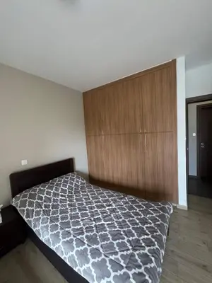 a bedroom with a bed and a wooden cabinet at 3 bedroom seafront apartment in Limassol