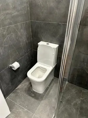 a bathroom with a white toilet in a shower at Ayia Napa 1 Studio in Ayia Napa