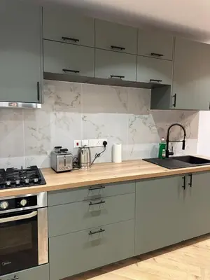 a kitchen with white cabinets and a counter top at Ayia Napa 1 Studio in Ayia Napa