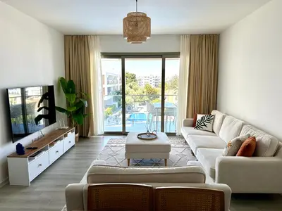 a living room with a couch and a tv at Bohemian penthouse in Girne Alsancak, close to Merit hotels in Kérynia
