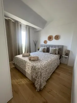a bedroom with a bed with two pillows on it at Trinity Getaway in Paralimni