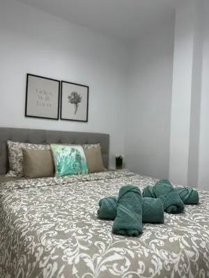 a bed with four green pillows on it at Trinity Getaway in Paralimni
