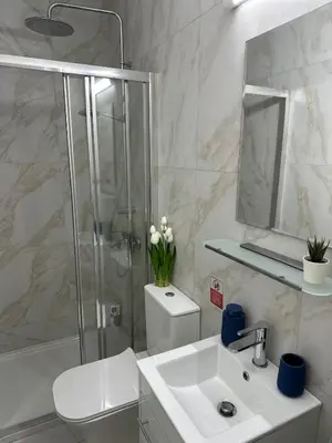 a bathroom with a shower and a sink and a toilet at Trinity Getaway in Paralimni