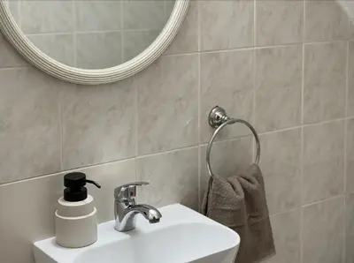 a bathroom with a sink and a mirror at 5-Min Walk to Beach - Bright 2-BR Home with Private Garden & Sunset Views in Voroklini