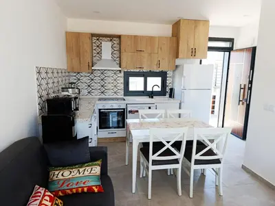 a kitchen and living room with a table and chairs at LJ Park Penthouse North Cyprus