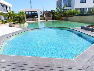 a swimming pool with blue water in a building at LJ Park Penthouse North Cyprus