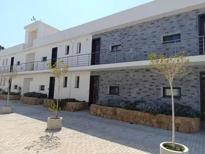 a building with trees in front of it at LJ Park Penthouse North Cyprus