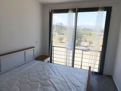 a bedroom with a bed and a large window at LJ Park Penthouse North Cyprus