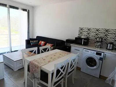 a kitchen with a table and a washing machine at LJ Park Penthouse North Cyprus