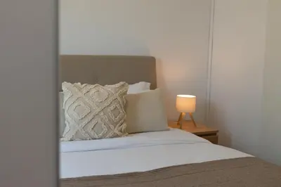 a bedroom with a bed and a lamp on a table at Limassol Sunbliss by Staycom in Limassol