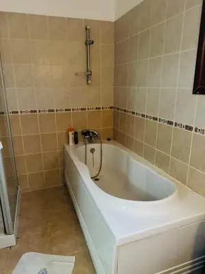 a bath tub in a bathroom with a sink at A Spacious Villa to Entertain in Aglantzia