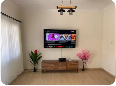 a living room with a flat screen tv on the wall at A Spacious Villa to Entertain in Aglantzia