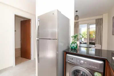 a kitchen with a refrigerator and a washing machine at Malama 2 Villa Ekaterina 2 bedroom in Paralimni