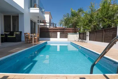 a swimming pool in the backyard of a house at Malama 2 Villa Ekaterina 2 bedroom in Paralimni