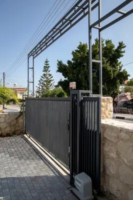 a gate in a fence next to a stone wall at Apartment Northern Cyprus