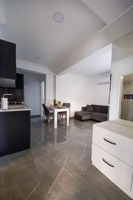 a kitchen and living room with a table and a couch at Apartment Northern Cyprus