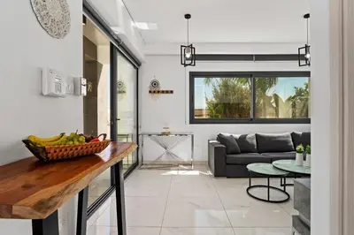 a kitchen and living room with a table and a couch at Villa Alassia 16 by Ezoria Villas in Paralimni