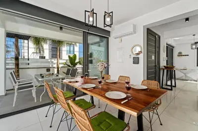 a dining room with a wooden table and chairs at Villa Alassia 16 by Ezoria Villas in Paralimni