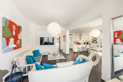 a living room with white furniture and blue accents at Protaras Seaside Villa Narcissos 16 in Protaras
