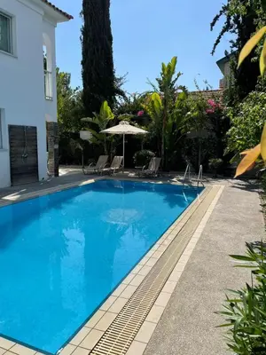 a large blue swimming pool next to a house at Villa Samantha in Paralimni