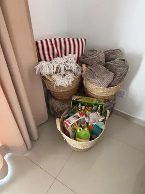 a room with three baskets and a chair with toys at Villa Samantha in Paralimni