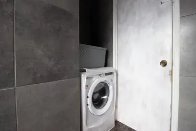 a washing machine in a bathroom next to a door at Central 1BR - Views - Deli Café in Nicosia