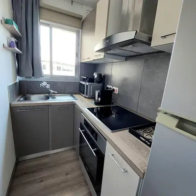 a small kitchen with a sink and a stove at Central 1BR - Views - Deli Café in Nicosia