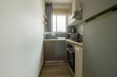 a small kitchen with a stove and a window at Central 1BR - Views - Deli Café in Nicosia