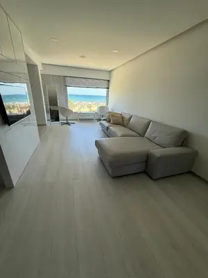 a large living room with a couch and a television at Marimar2 paradise by the Sea in Larnaka
