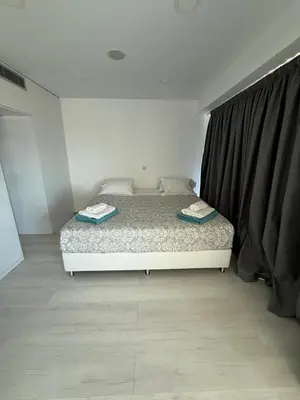 a bedroom with a bed with two towels on it at Marimar2 paradise by the Sea in Larnaka