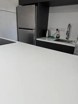 a kitchen with a stainless steel refrigerator and a sink at Marimar2 paradise by the Sea in Larnaka